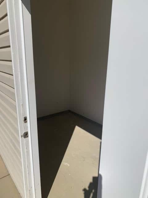A secure door to a storage unit in a garage.