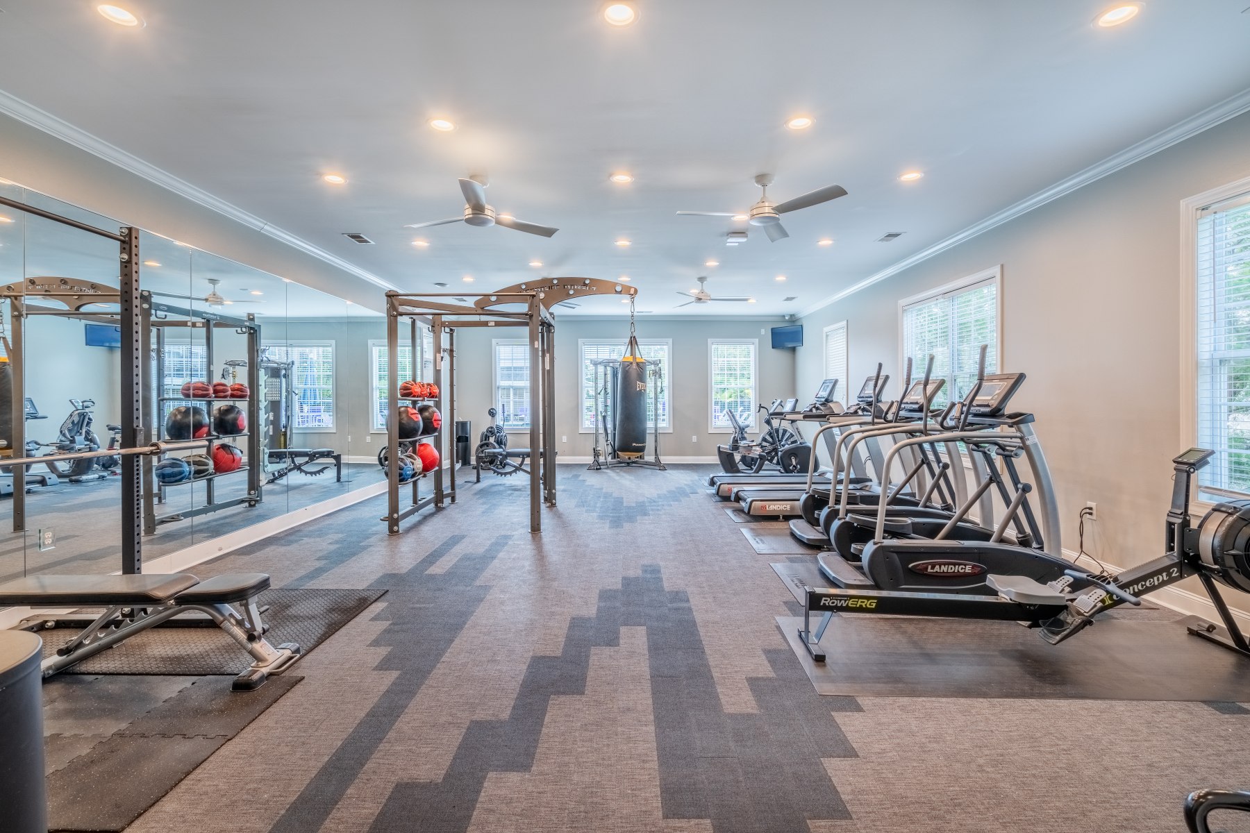 Apartments in Fayetteville, North Carolina Stone Ridge Apartments offers a modern gym equipped with treadmills, exercise bikes, weight racks, and benches. Large mirrors and windows flood the space with natural light, making it an inviting place for residents to stay active. Stone Ridge Apartments in Fayetteville 3001 Stone Carriage Circle Fayetteville, NC 28304